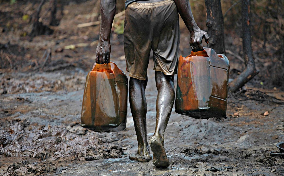 A man works at an illegal oil refinery site near river Nun in Nigeria's oil state of Bayelsa
